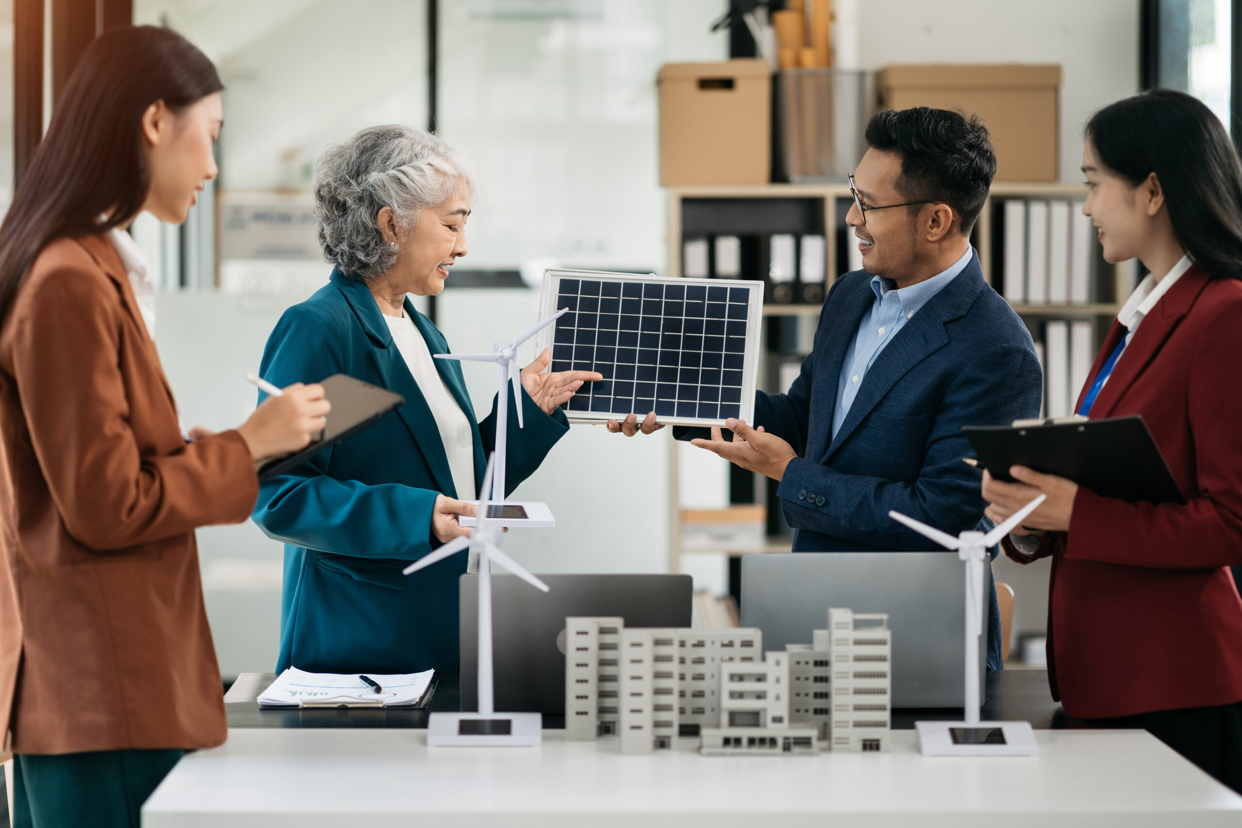 businessman team brainstorming using tablet, laptop computer for working technology and business, renewable energy based green businesses and global warming. green energy and solar panel concept.